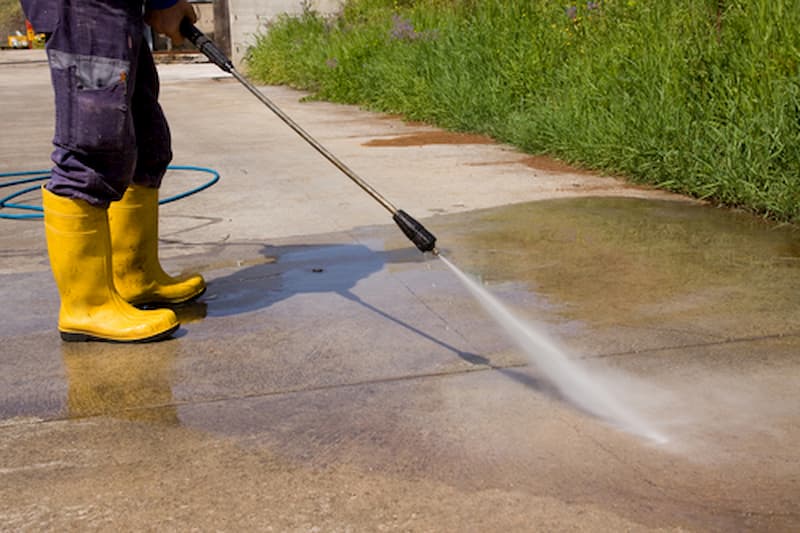 Pressure washing a concrete driveway in Alliance, Ohio