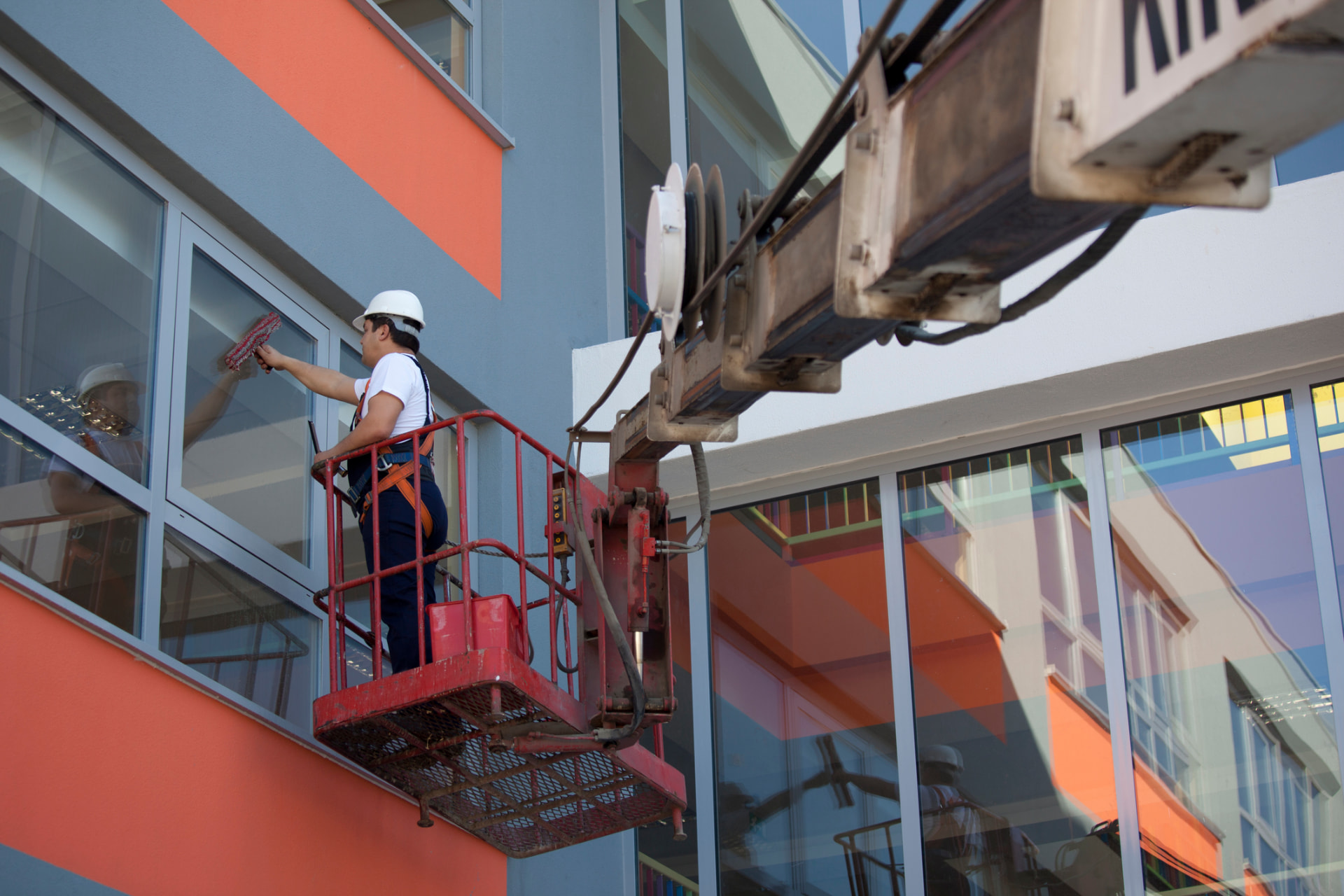 Window cleaner on a lift washing commercial glass in downtown Kent, Ohio