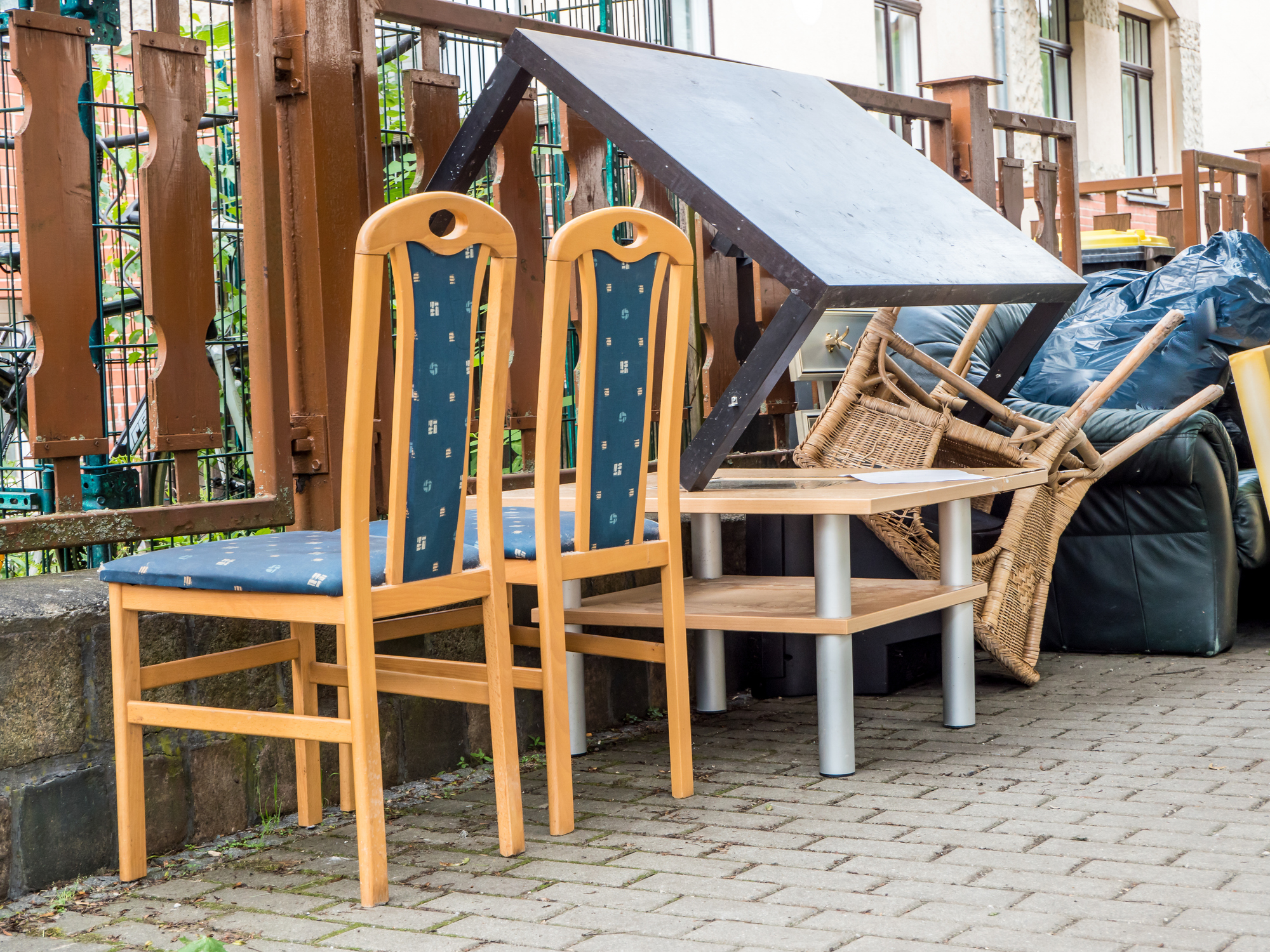 Old furniture and household items set out at the curb for junk removal in Alliance, Ohio